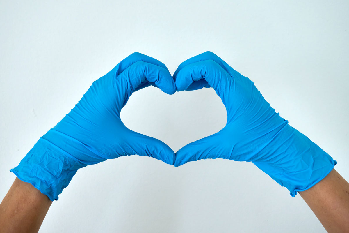 hands in surgical gloves making heart