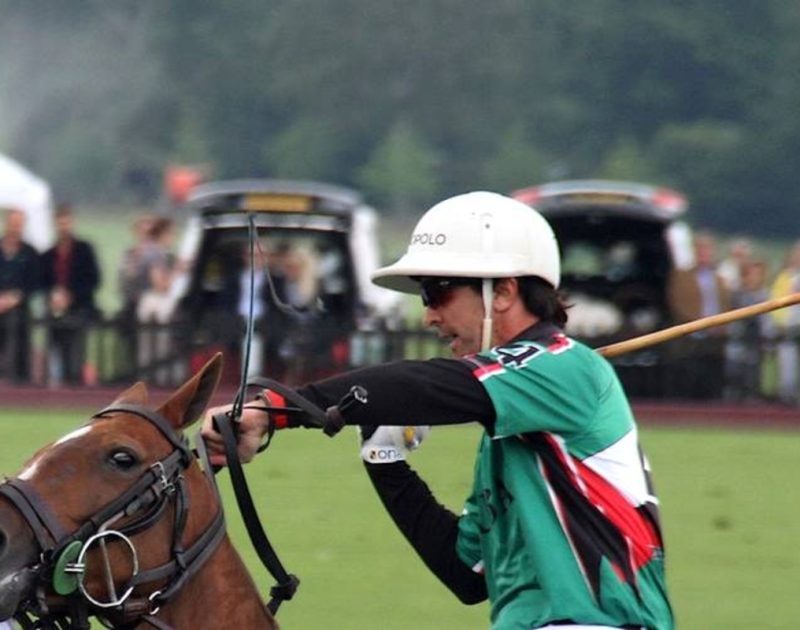 man rides horse in polo match