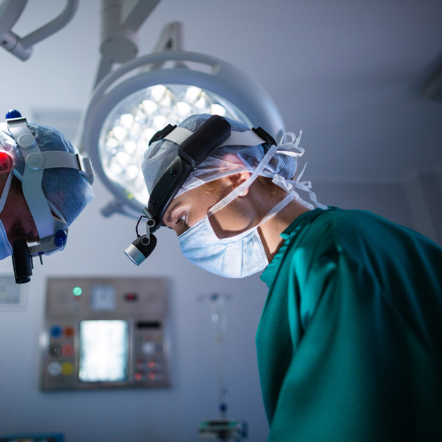 image of two surgeons performing microvascular surgery