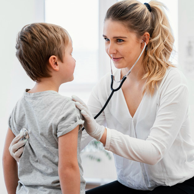 Doctor listens to child patients chest with stethoscope