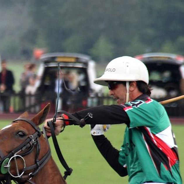 man rides horse in polo match