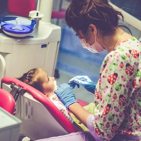 Dentist treating child